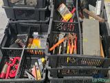 many different types of tools in crates on the ground