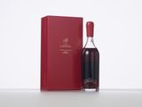 a bottle of wine sitting next to a red box