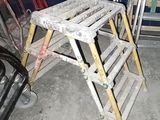 a ladder that is sitting next to a chair in a room