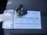 a car key sitting on top of a piece of paper with a note attached to it
