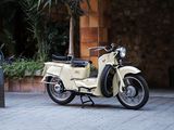 a moped that is parked on the side of the street