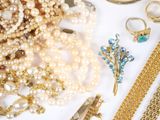 many different types of jewelry on a white surface
