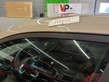 a car that has a sign on the windshield of it