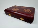 a small wooden box with a design on it
