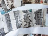 a lot of old black and white photos on a table