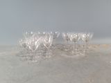 several empty wine glasses sitting on top of a cement floor