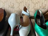 three pairs of women ' s shoes sitting on top of a box