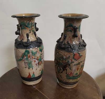two vases that are sitting on a table