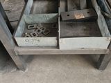 a metal workbench with a drawer full of tools on it