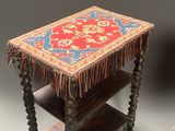 a small table with a red and blue rug on it