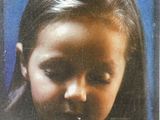 a picture of a young girl with a nose ring
