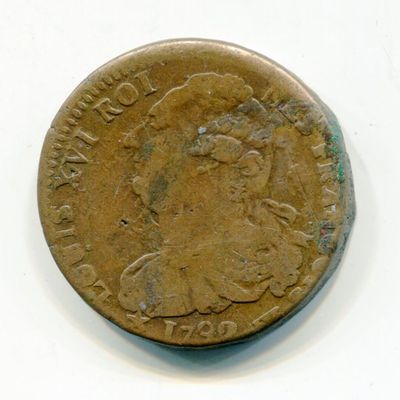an old coin with a woman on it on a white surface