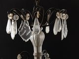 a crystal chandelier hanging from a black ceiling