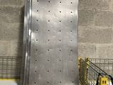 a large metal refrigerator sitting on a shelf in a room