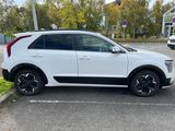 a white suv parked in a parking lot next to a building
