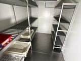 a small room with shelves and shelves in it