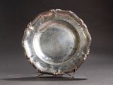 a silver plate that is sitting on a stand