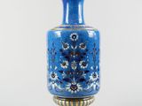 a blue vase that is sitting on a table