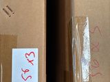 two boxes that are sitting on a shelf in a room