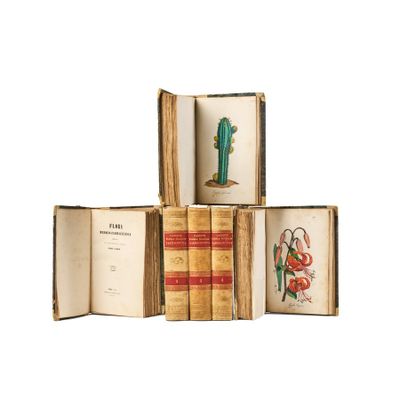 several old books are stacked on top of each other on a white surface