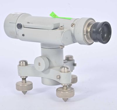 a close up of a camera on a tripod on a white background