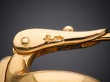 close up of a gold plated duck head on a blue bowl
