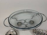 a glass bowl with spoons in it on a table