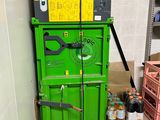 a green machine that is sitting in the corner of a room