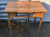 a small wooden table with a drawer underneath it