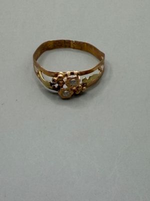 an image of a gold ring on a white surface