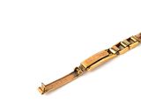 an image of a close up of a gold bracelet on a white surface