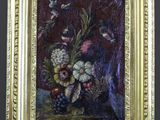 an oil painting of flowers in a vase on a easel