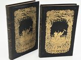 two black and gold book covers with gold designs on them