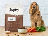 a dog that is sitting next to a bag of dog food