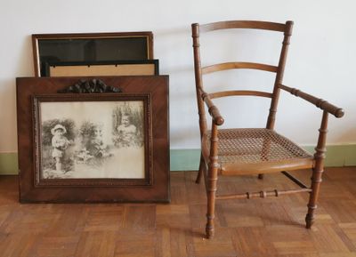 une chaise et un tableau posé par terre à côté d'une chaise