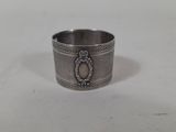 a close up of a silver ring on a white surface