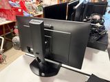 two computer monitors sitting on a table in a store