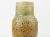 a vase that is sitting on a white surface