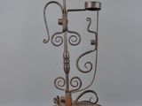 wrought iron candelab with candle holders on top of it