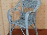 a blue wicker chair in a corner of a room