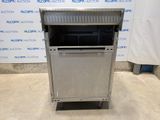 a stainless steel dishwasher sitting on wheels in front of a wall