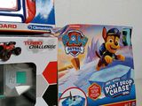 two boxes of toys on a table with a remote control