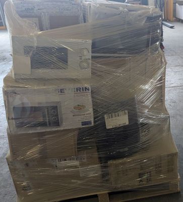 a stack of televisions sitting on a pallet in a warehouse