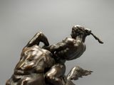 bronze statue of a man and a woman on a horse