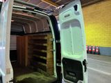 a white van with its door open in a warehouse