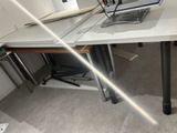 a laptop computer sitting on top of a white desk