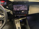 the interior of a car with a steering wheel, dashboard, and display screen