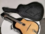 a guitar in a case sitting on a white table
