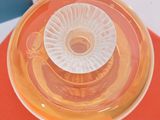 a glass bowl with a plastic lid sitting on a table