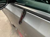 a close up of a car door handle with a sticker on it
